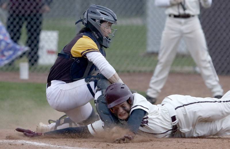 Jacobs’s Grant Helbig tags out Prairie Ridge's Jimmy Stone as he tries to steal home during a Fox Valley Conference baseball game Friday, April 29, 2022, between Prairie Ridge and Jacobs at Prairie Ridge High School.