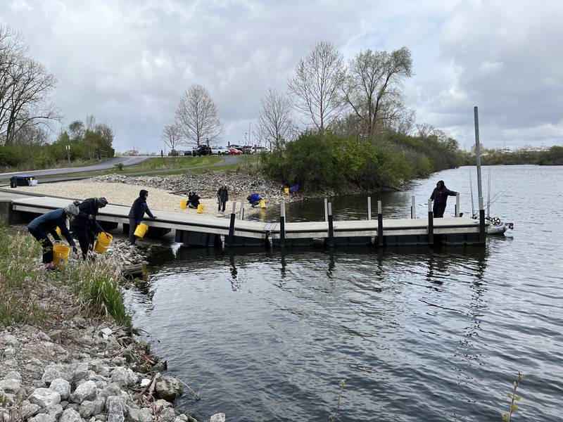 Volunteers help clean up plastic trash and other litter on Saturday at the Rock Run Rookery Preserve in Joliet. The cleanup was hosted by the Forest Preserve District of Will County in recognition of Earth Day.