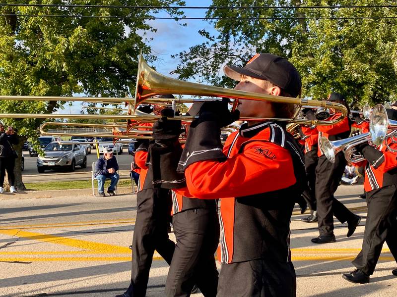 Trombone players perform as part of the DeKalb High School Marching Band during the annual DeKalb High School Homecoming Parade on Wednesday, Sept. 24, 2025, along West Dresser Road.