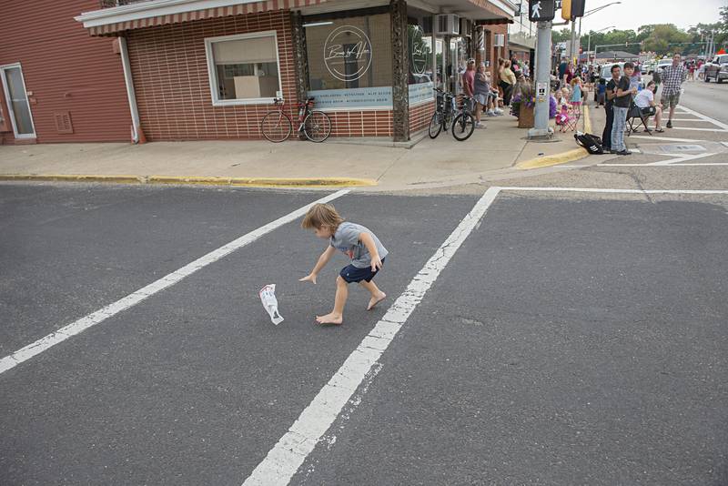 A wind-blown bag eludes a child Saturday during the Fiesta Parade.