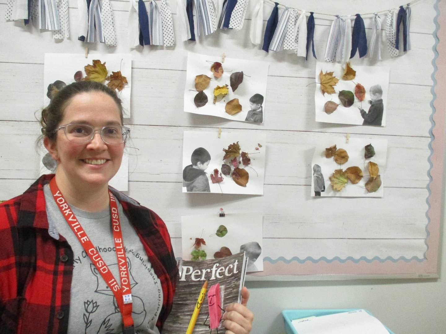 Teacher Kari Brestan stands before artwork created by her students at the Yorkville School District Y115 Early Childhood Center, during an open house on Nov. 9, 2022.
