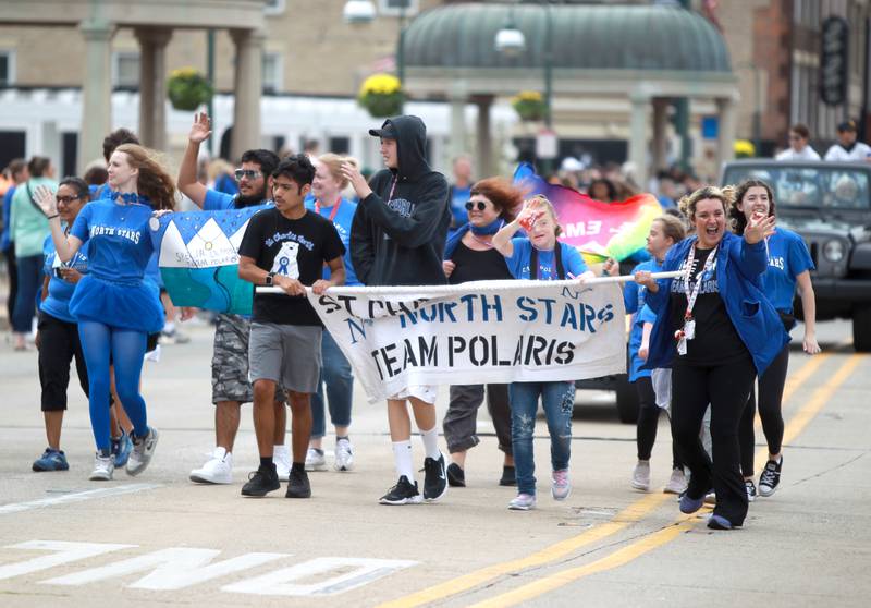 Members of the St. Charles North Team Polaris club walk on Route 64 on Friday, Sept. 27, 2024 during the school’s annual homecoming parade in St. Charles.