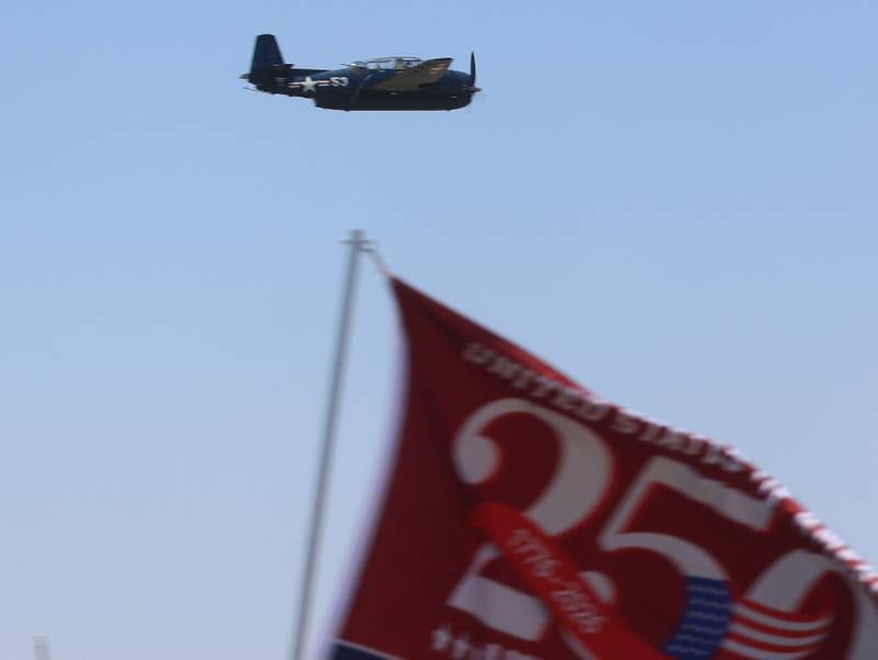 A TBM Avenger flies over a United Stated 250th anniversary flag during the 11th annual TBM Reunion and Air Show on Friday, May 15, 2026 at the Illinois Valley Regional Airport in Peru.