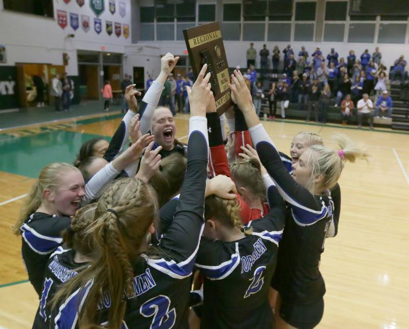 Members of the Newark volleyball team hoist the 1A Regional plaque after defeating St. Bede on Thursday, Oct. 27, 2022 at the Academy in Peru.