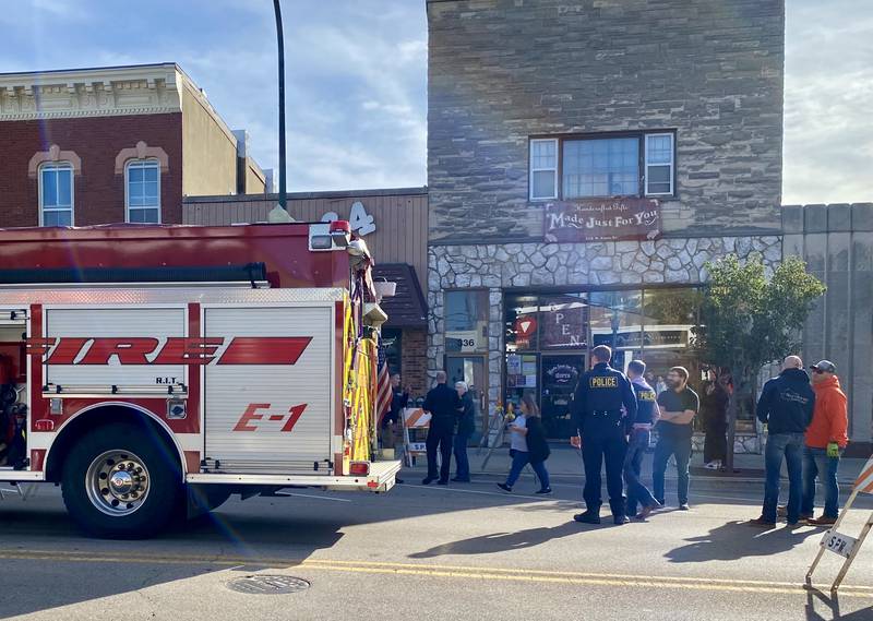 A Sycamore Fire Department truck sits in front of the 300 block of West State Street in downtown Sycamore as police and other authorities respond to a vehicle which crashed into the front of Atlas Roots Collective women's clothing store on Friday, Oct. 24, 2025. The area is roped off from the public. The crash injured a driver and passenger, said Deputy Police Chief Joseph Meeks.