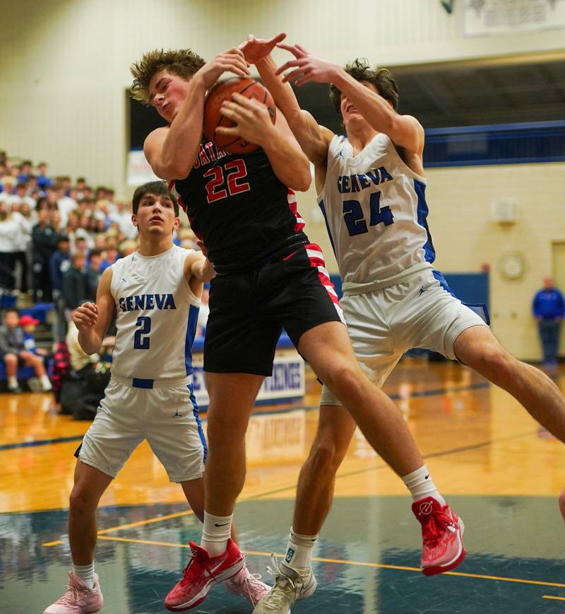 Batavia’s Charlie Whelpley (22) rebounds the ball against Geneva’s Luke Matan (24) during a basketball game at Geneva High School on Friday, Dec 15, 2023.