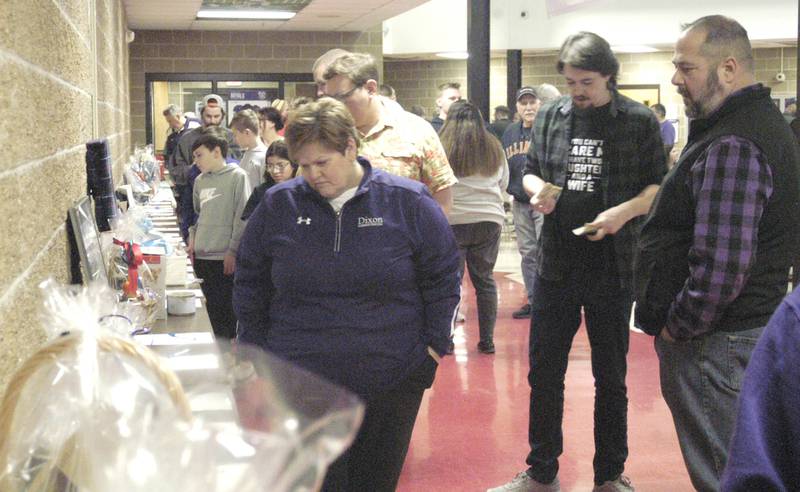 The crowd at the Dixon Stupor Bowl looks over items in the silent auction. The event was held Saturday, Feb. 8, at Reagan Middle School in Dixon.