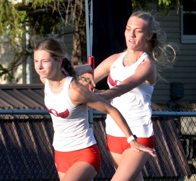 Oregon's Skylar Bishop hands the baton to Taylor Weems in the 4x100 relay at the 1A Lena-Winslow sectional on Thursday, May 15, 2025. The Hawks finished third in this event and qualified for the state meet at Eastern Illinois University in Charleston.