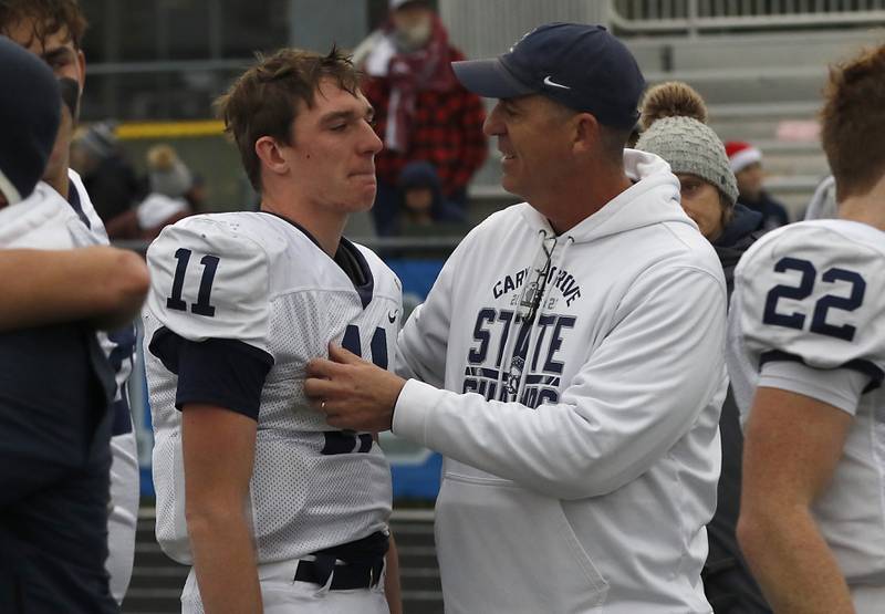 Cary-Grove's Peyton Seaburg is comforted by his dad and coach Brad Seaburg after Cary-Grove was defeated by Geneva IHSA Class 6A semifinal football game on Saturday, Nov. 23, 2024, at Geneva High School.