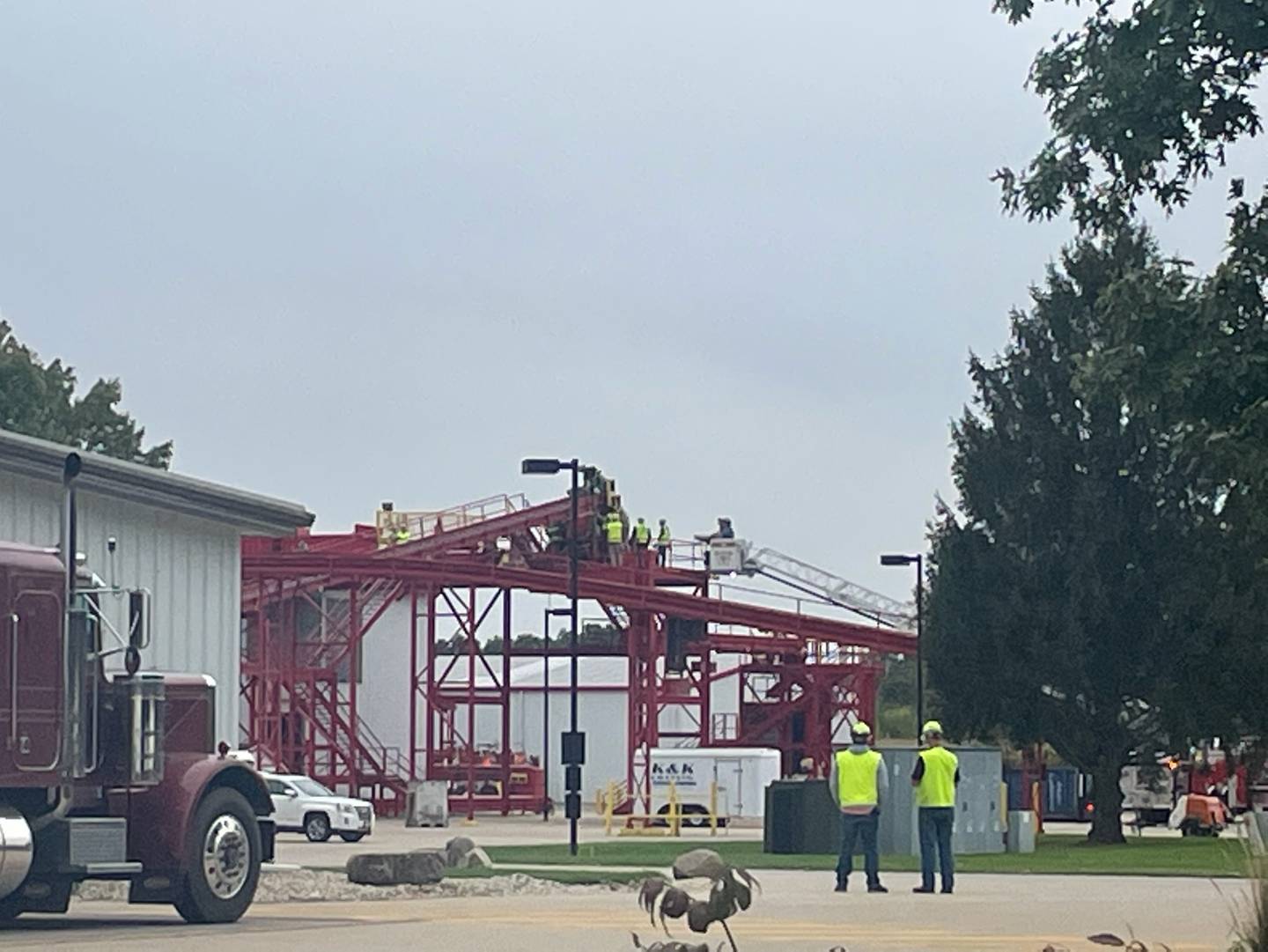 Firefighters freed a woman who was trapped in a conveyer belt about 40 feet above the ground at a Utica agricultural facility.