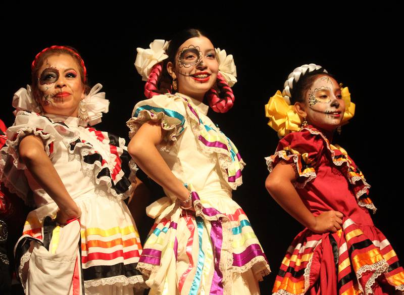 Rosario Bahena, of Waukegan, director, Victoria Casas, 14, of Round Lake and Yaretzi Fernandez, 11, of Mundelein perform with the Mexico en La Piel Folkloric Dancers during the Day of the Dead Celebration at the Round Lake Beach Cultural & Civic Center.