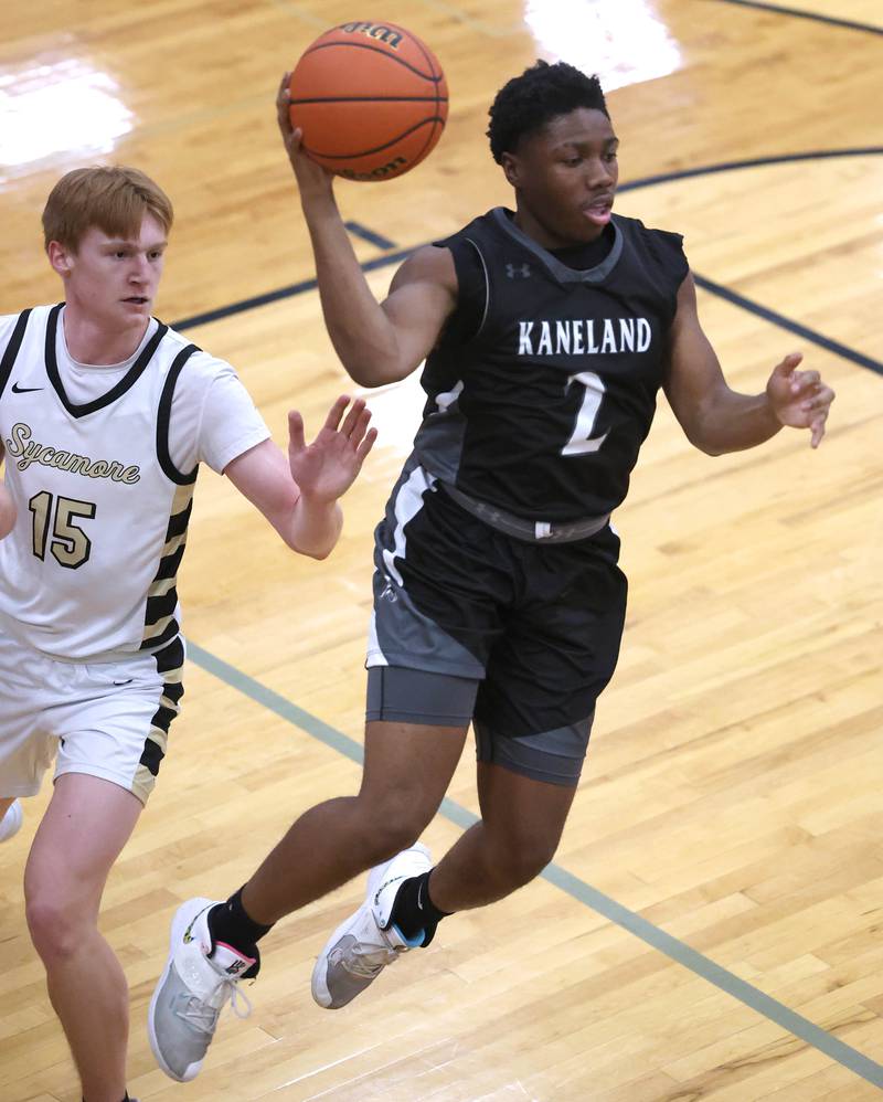 Kaneland's Gevon Grant passes the ball away from the defense of Sycamore's Teague Hallahan during their game Friday, Feb. 10, 2023, at Sycamore High School.