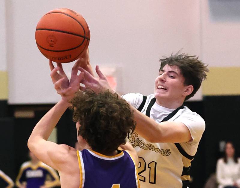 Sycamore's Ben Larry grabs a rebound over Mendota's Jace Baird during their game Wednesday, Dec. 13, 2023, at Sycamore High School.