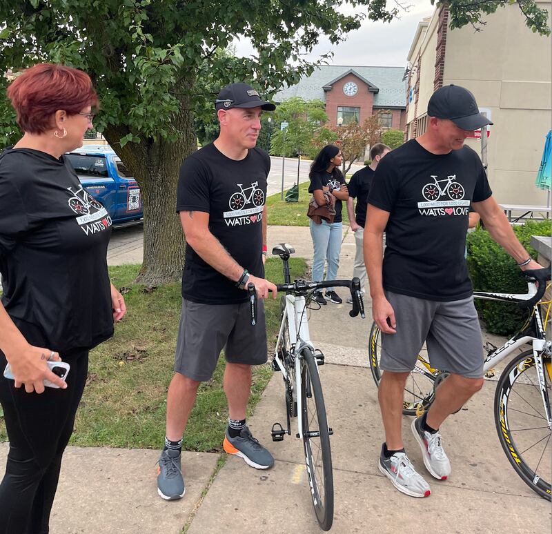 Jessica Hein (left) stands next to her husband Scott and Todd Wilson Friday evening shortly after they arrived at a Watts of Love fundraiser celebration at the Downers Grove Moose Lodge. The celebration took place shortly after Scott Hein and Wilson completed a 1,000-mile bike trip designed to raise money for Watts of Love.