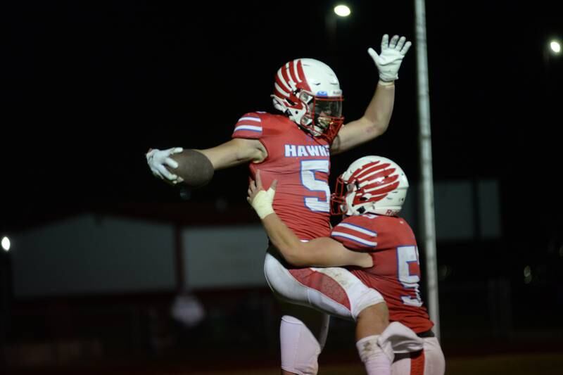 Oregon's Hunter Bartel (5) celebrates with Seth Rote (53) after scoring a touchdown against Stillman Valley on Friday, Oct. 4, 2024 at Landers-Loomis Field in Oregon.