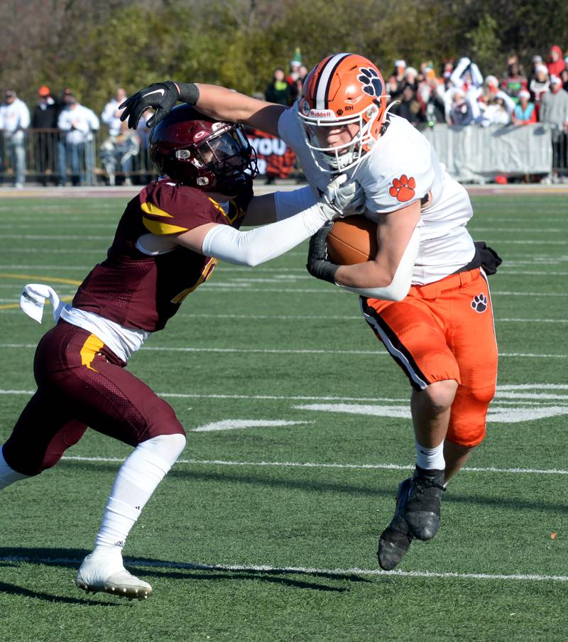 Byron's Brayden Knoll (1) fights off a Lombard-Montini defender during 3A semifinal action in Lombard on Saturday, Nov. 18, 2023.