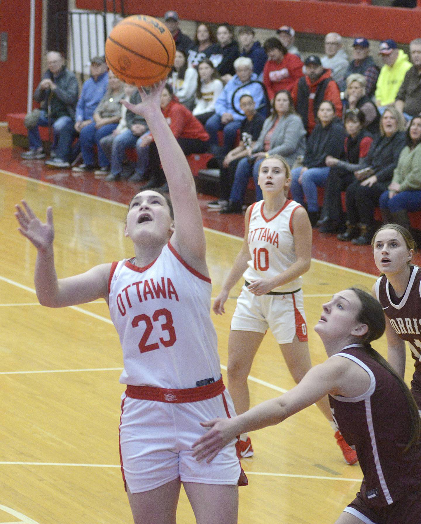 Ottawa’s Mary Stisser gets shot over the block of Morris’s Lily Hansen in the first quarter of Saturday's championship game of the Ottawa Holiday Tournament.
