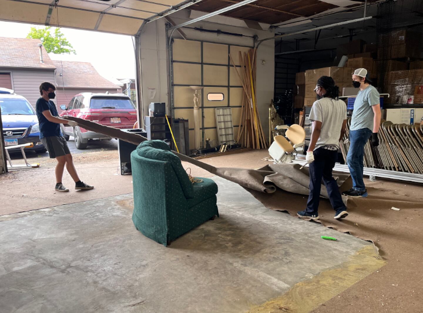 The Golden Ratio team renovates their new workshop by removing old carpet and cleaning out the garage.