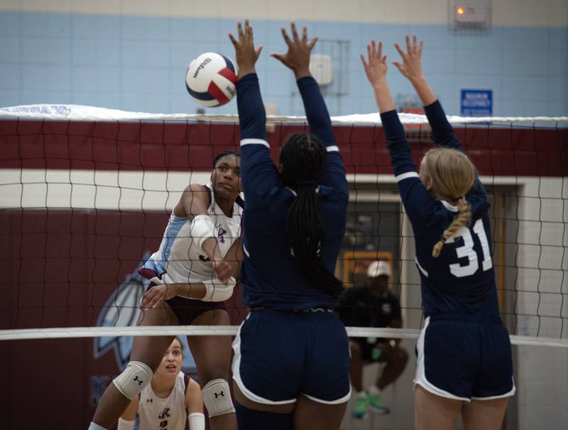 Kankakee's Erin Wills delivers a hit over the net as Grace Christian's Miranda Glenn, center, and Chloe Dandurand, right, defend in a match on Monday, September 22, 2025.
