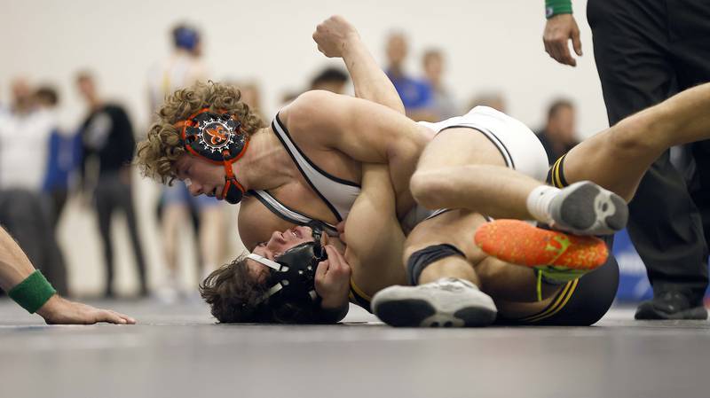 St. Charles East’s Logan Tatar wrestles Glenbard North’s Angelo Gatses at 144-lbs at the 2025 DuKane Boys Varsity Tournament Saturday, Jan. 25, 2025 in St. Charles.