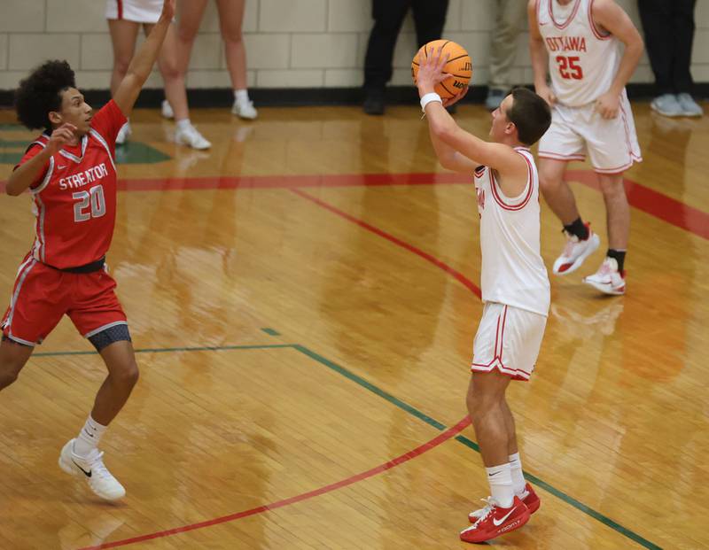 Ottawa's Rory Moore fires a three-point jump shot over Streator's Jerrimahia Jones during the Class 3A Regional semifinal game on Wednesday, Feb. 25, 2026 in Sellett Gymnasium at L-P High School.