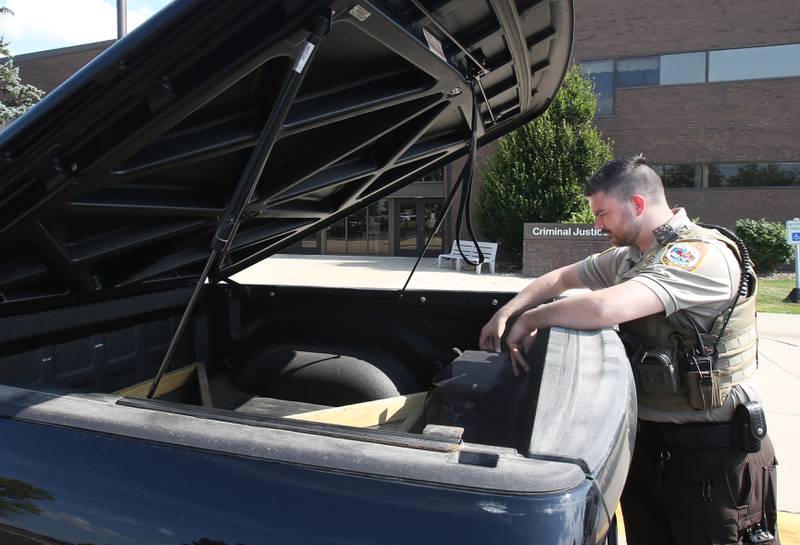 La Salle County Sheriff's Deputy Riley Pode checks his equipment before departing for his shift on Wednesday, July 2, 2025, at the La Salle County Government Complex in Ottawa. Not long ago, police chiefs and sheriffs reported a dangerous lack of new recruits thanks to a political environment that deterred young people from pursuing law enforcement careers. Pode is among the young officers who helped reverse the trend.