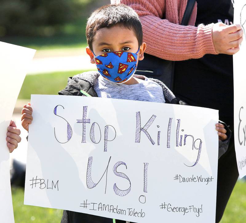 Deangelo Coleman, 5, from DeKalb, stands with other protesters Friday in front of the DeKalb Police Department. The protest, organized by the group For the People-DeKalb, was marching against police brutality on the heels of Duante Wright's shooting by police in Minnesota, the Derek Chauvin trial for the death of George Floyd and the release of the video of the police shooting of 13-year-old Adam Toledo in Chicago.