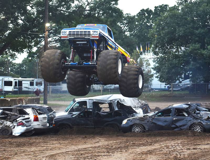 A Monster truck clears a row of cars at the Whiteside County Fair on Thursday, Aug. 15, 2024.