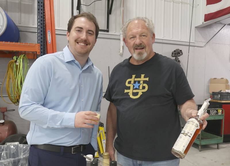 Lucas Burris poses with Bob Windy owner of Star Union Spirits during the Illinois Valley Chamber of Commerce held its annual block party on Wednesday, April 29, 2029 at the Illinois Valley Regional Airport in Peru. Burris will be the next Illinois Valley Chamber of Commerce director in August.