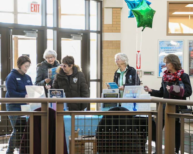 Dawn Hartman, left, of the Downers Grove Park District talk with community member on Saturday Jan. 11, 2025, with programs they offer during the FitFest event held at the Downers Grove Park District recreation center.
