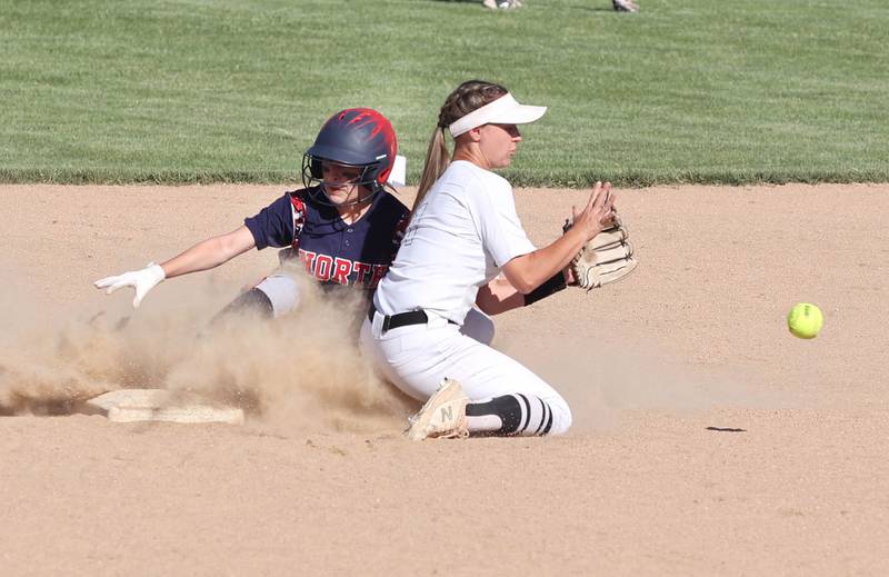 Kaneland's Kailey Plank takes the throw as Belvidere North's Jacqueline Alvarez slides in safely with a stolen base Friday, June 3, 2022, during their IHSA Class 3A Sectional final game at Sycamore High School.