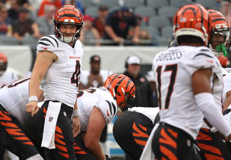 Former Northern Illinois University and current Cincinnati Bengals quarterback Rocky Lombardi sends a man in motion while making his NFL debut Saturday, Aug. 17, 2024, at Soldier Field in Chicago. Lombardi checked in during the second half of a 27-3 loss to the Chicago Bears. Lombardi is competing for a roster spot with the Bengals.