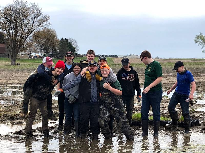 Boy Scout of America Tropp 2810 member Quinn Harrelson with volunteers at his restore wetlands Eagle's Project