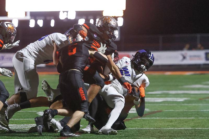 Minooka’s defense brings down Lincoln-Way East’s Zion Gist for no gain on Friday, Nov. 8, 2024 in Minooka.