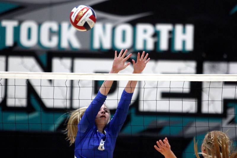 Woodstock’s Samantha Karner blocks in varsity volleyball at Woodstock North Monday night.