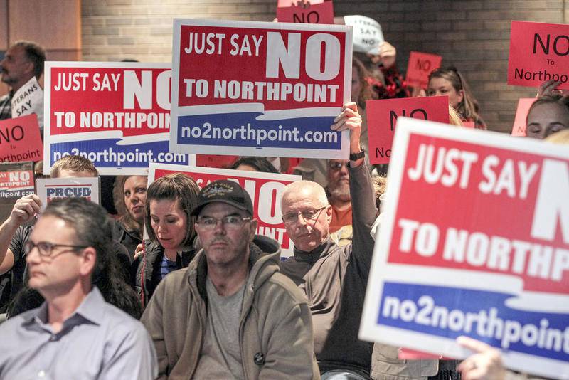 Opponents show their disagreement with the NorthPoint Development project at a Feb. 24 meeting of the Joliet Plan Commission.