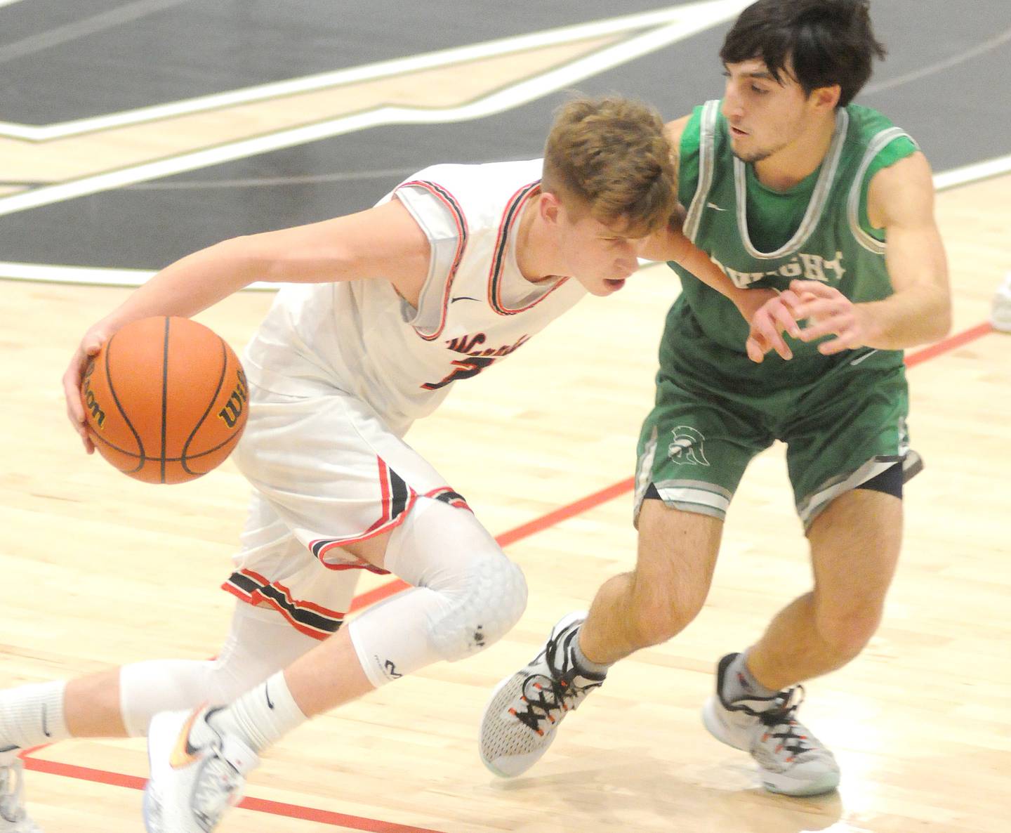 Woodland's Tucker Hill dribbles past Dwight's Jack Duffy at the Warrior Dome on Friday, Jan. 13, 2023.
