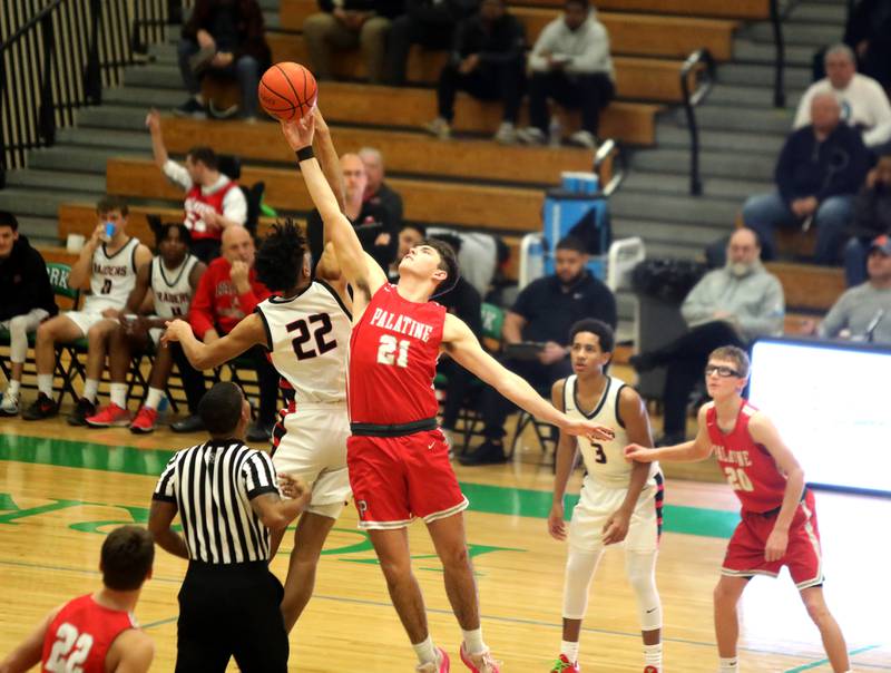Bolingbrook’s JT Pettigrew (left) and Palatine’s Connor May go for the tip-off during the Jack Tosh Holiday Classic semifinals at York High School in Elmhurst on Friday, Dec. 29, 2023.