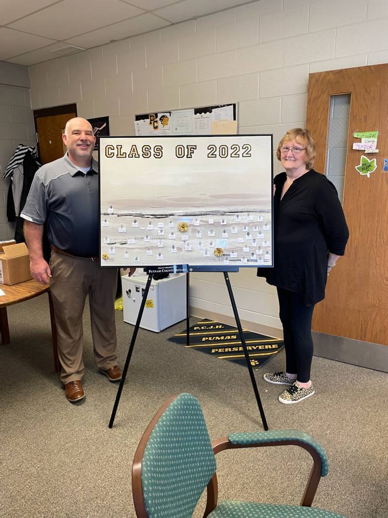 Rotarians Mike Olson and Brenda Bickerman display the final monthly"life lessons" bulletin board on display at Putnam County Junior High School in McNabb. Mr. Olson is Principal and Interact Club faculty advisor, and Ms. Bickerman is the Rotary's liaison to the Interact Club that is sponsored by Putnam County Rotary. The bulletin board project was honored at Rotary's District Conference in Moline last Sunday for its innovative and interactive approach in teaching students self worth and encouraging their full potential.