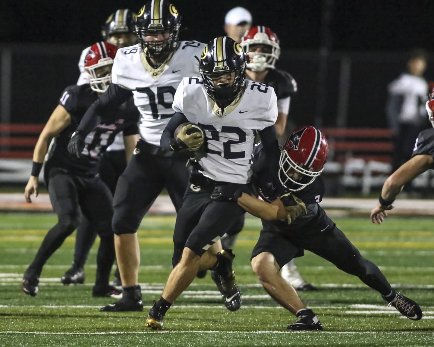 Glenbard North's Donato Gatses (22) fights off the tackle attempt by Yorkville's Luke Hendershott (3) during Class 7A first round football game between Glenbard North at Yorkville. Friday, Oct 31, 2025 in Yorkville.