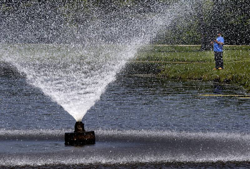 A man fished Wednesday, May 24, 2023, near the fountain at Emricson Park in Woodstock.