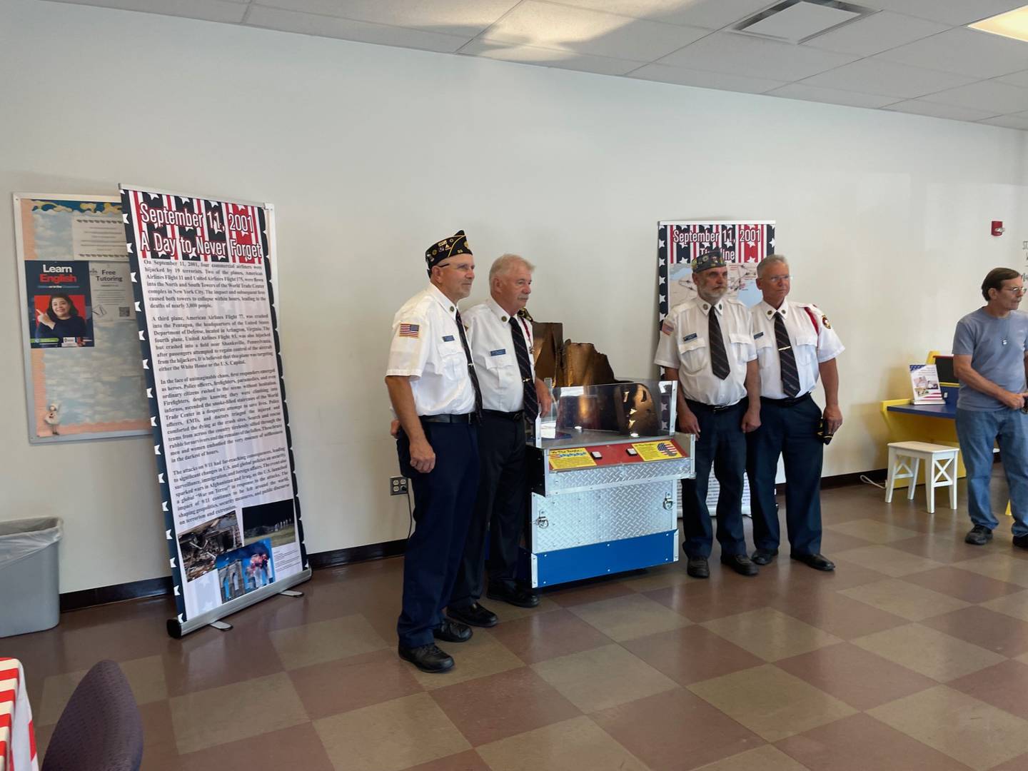 Members of American Legion Post 33 pose for a photo Saturday, July 6, 2024, at the "We The People" exhibit commemorating the Sept. 11 terror attacks. The exhibit is on display through July 31 at the IVCC annex in Ottawa.
