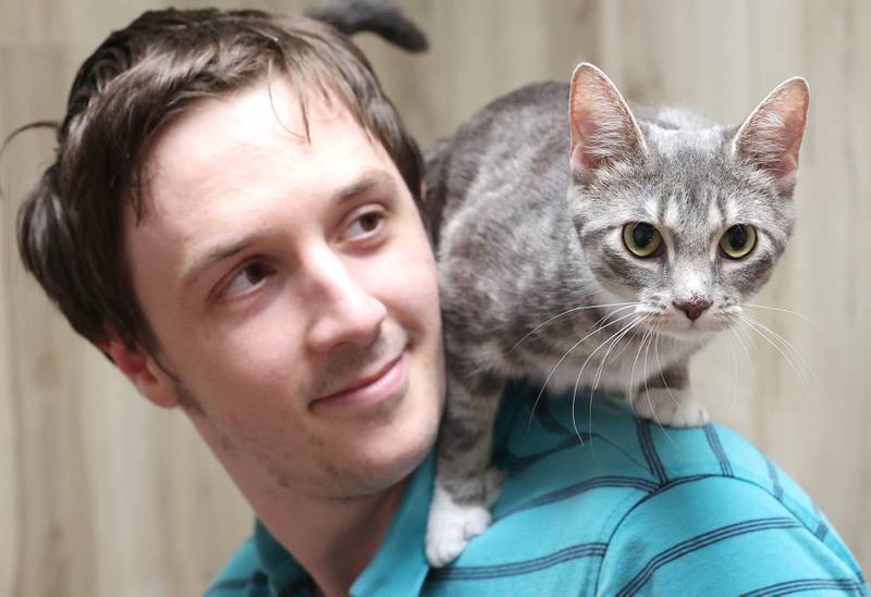 Keith Camenisch with a cat Monday, July 24, 2023, that soon may be available for adoption at Tails Humane Society in DeKalb. Tails will be hosting  the Tails on Tap Bar Crawl Saturday Aug. 5 in downtown DeKalb with all proceeds benefitting the homeless pets at the shelter.