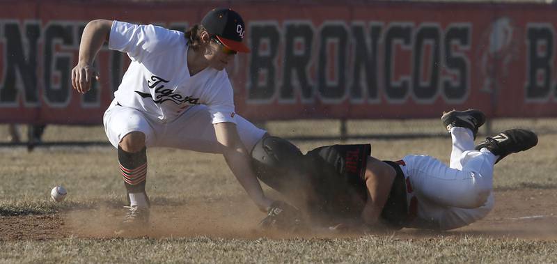Crystal Lake Central’s Braydon Gibour looses the ball as he tries to tag out Barrington’s Nick Lacson during a non-conference baseball game Tuesday, March 15, 2022, between Crystal Lake Central and Barrington at Barrington High School.