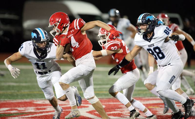 Naperville Central's Logan Devick moves past Downers Grove South's Dylan Spencer (11) Friday October 27, 2023 in Naperville.