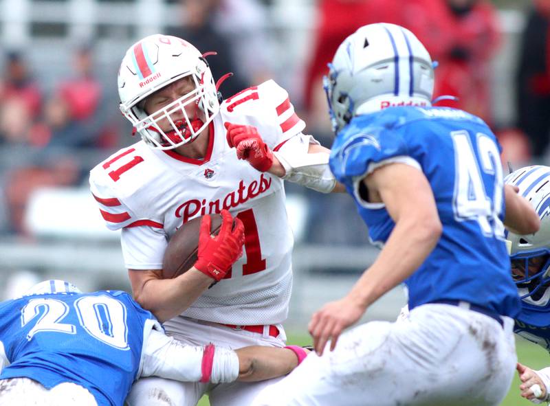 Ottawa’s Weston Averkamp runs the ball in varsity football at Larry Dale Field on the campus of Woodstock High School Saturday.