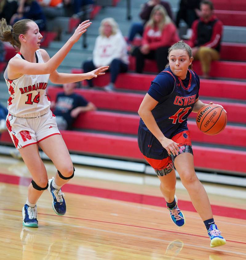 Oswego’s Kendall Grant (42) drives the baseline against Naperville Central during a basketball game at Naperville Central High School on Friday, Nov 17, 2023.