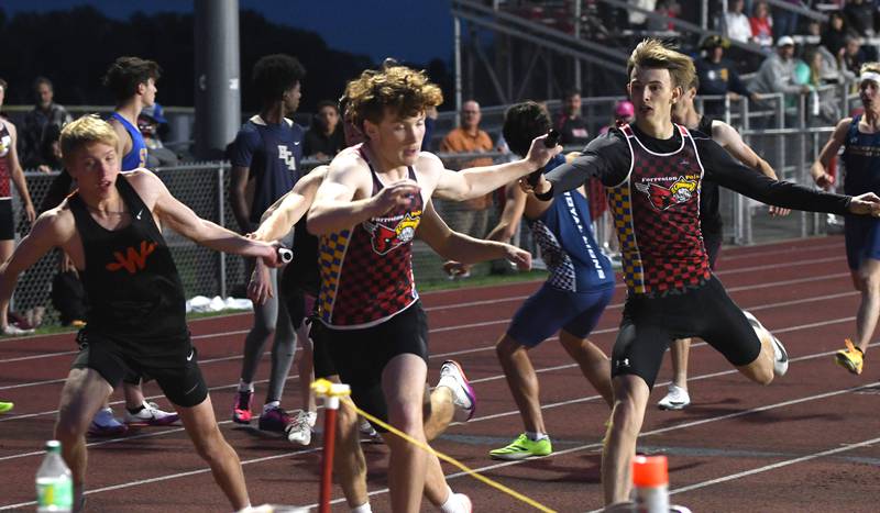 Forreston-Polo's Hayden Vinnedge hands the baton to Eli Ferris during an exchanve of the 4x400 relay at the 1A Oregon Sectional on Friday, May 22, 2026. The Cardinals won the race to advance to the state finals.
