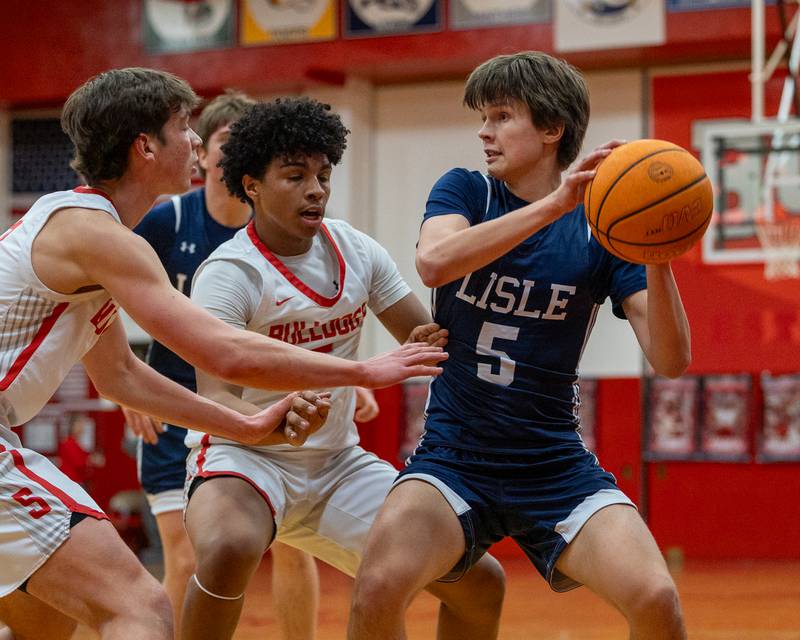 Lisle's Simas Dobilas (5) holds ball looking for pass as Streator's defense guards on Wednesday, Feb. 18, 2026 at Streator High School in Streator.
