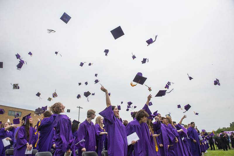 The Dixon High School class of 2022 throw their caps in the air after graduating Sunday, May 29, 2022.
